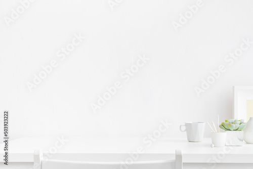 Home office, creative desk with office supplies and empty table space. White workspace. © mallmo