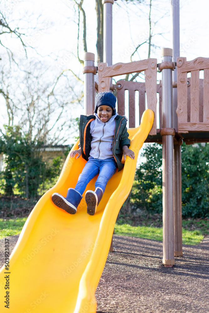 Boy on playground slide