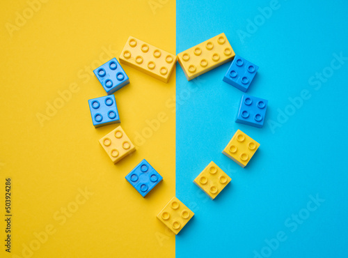 Plastic yellow-blue details of the children's designer in the shape of a heart. Children's educational game, top view photo