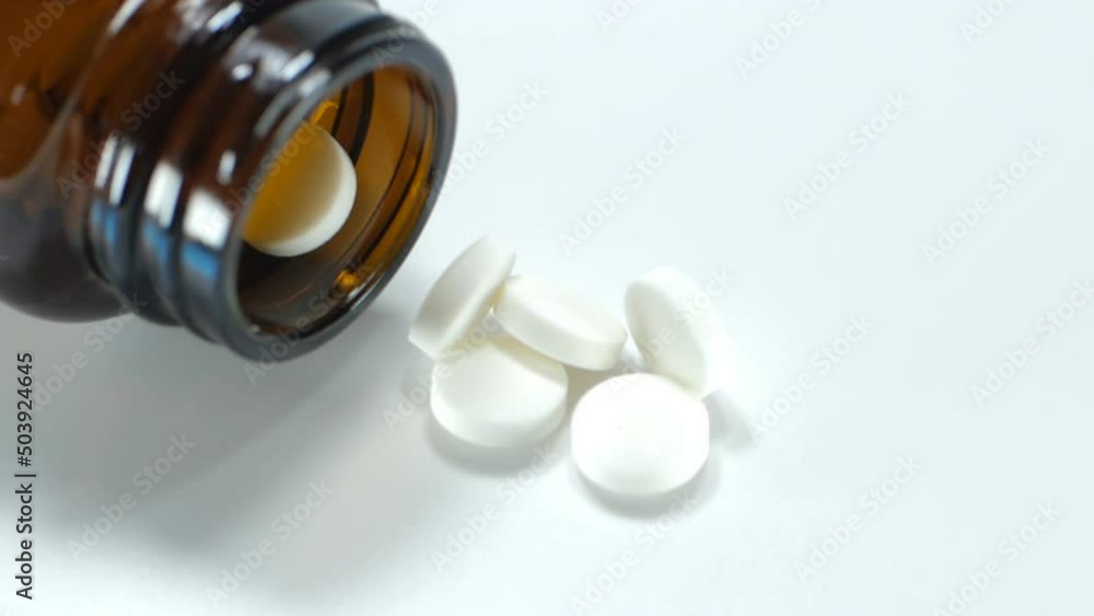 Close up slow motion medicine white color of pills rotation and pour the drug isolated on white background.Macro video. Close up slow motion medicine white color of pills rotation and pour the drug isolated on white background.Macro video.