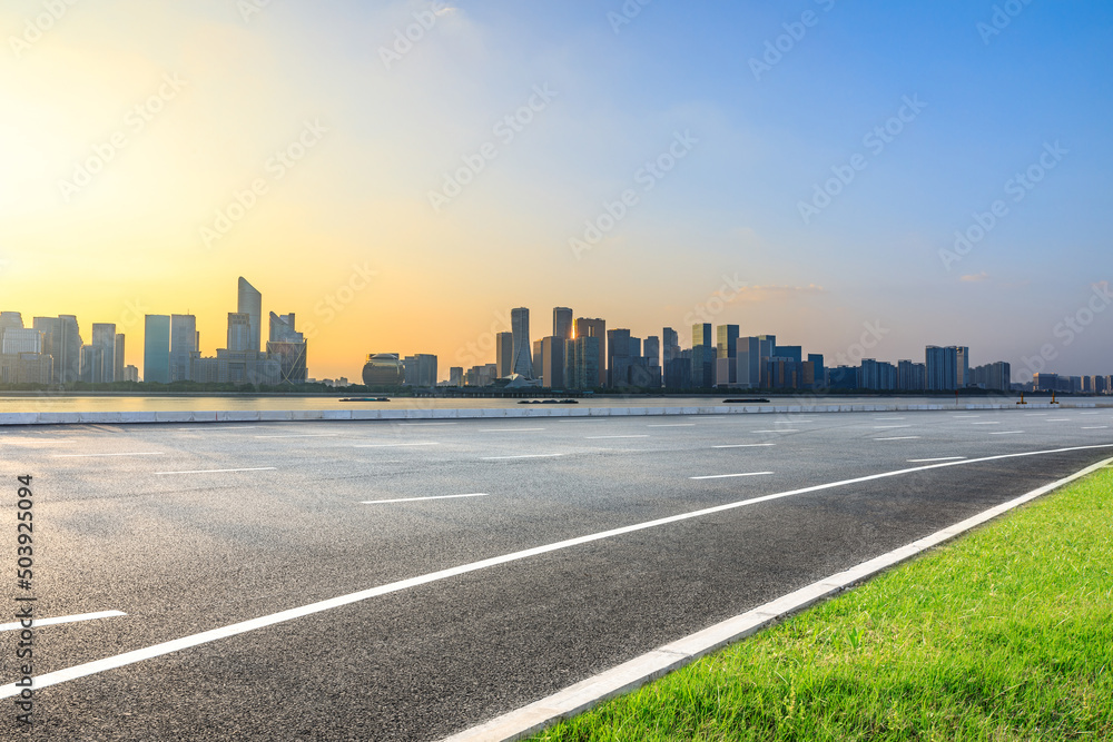 Fototapeta premium Asphalt road and modern city skyline with buildings in Hangzhou at sunset, China.