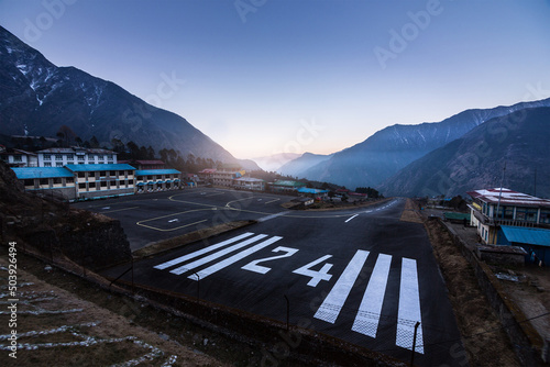 view of Lukla village and Lukla airport, Khumbu valley, Solukhumbu, Everest area, Nepal Himalayas, Lukla is gateway for Everest trek and Khumbu valley. One on the most dangerous airport in the world.  photo