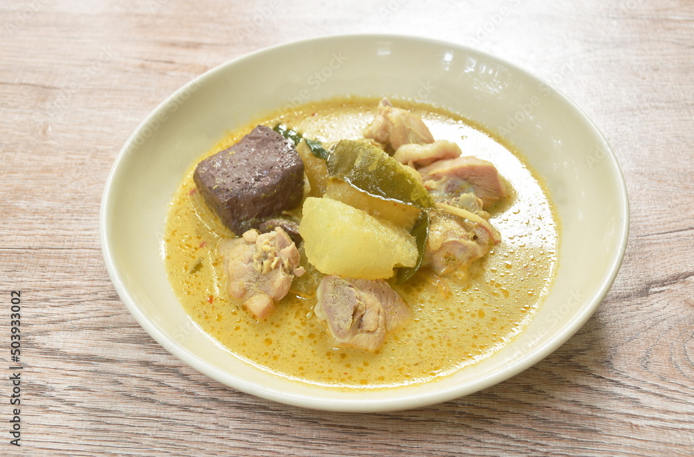 spicy boiled slice winter melon with chicken and blood in coconut milk green curry soup on plate spicy boiled slice winter melon with chicken and blood in coconut milk green curry soup on plate