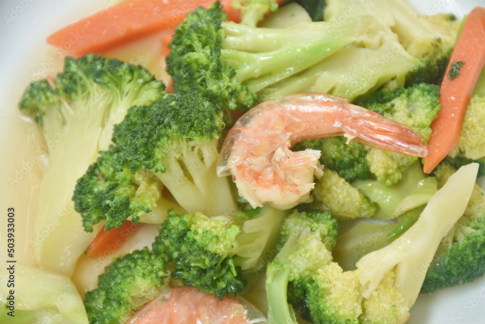 stir fried slice broccoli and carrot with shrimp on plate stir fried slice broccoli and carrot with shrimp on plate