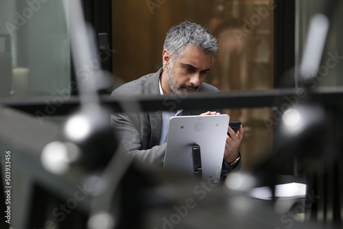 Businessman using smart phone and tablet