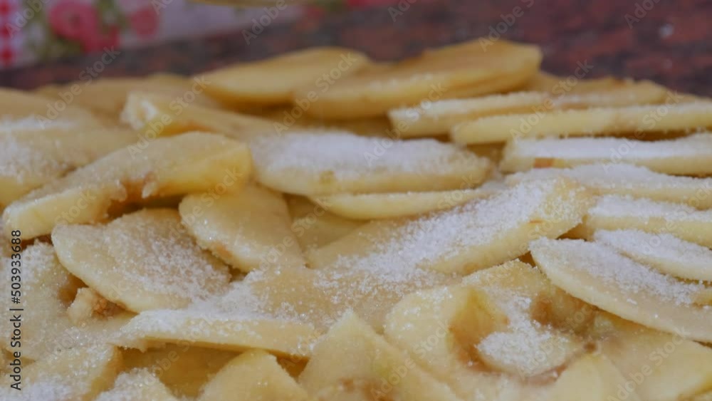 Baker female hands make an apple pie sprinkle sugar on top on the dough on home kitchen countertop. Shortbread dough Baker female hands make an apple pie sprinkle sugar on top on the dough on home kitchen countertop. Shortbread dough