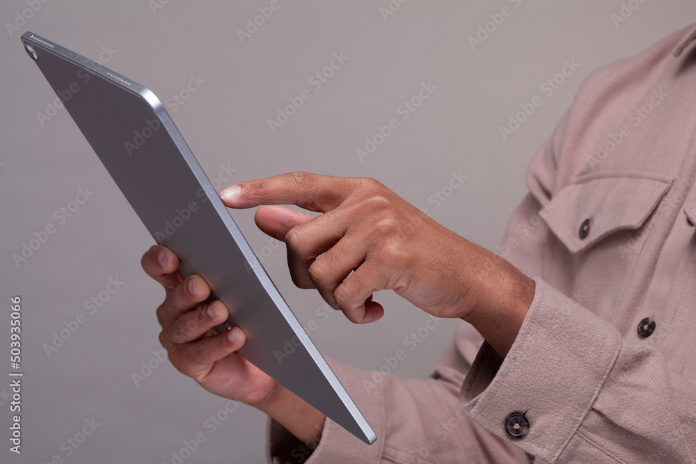 Close-up of male hands using digital tablet