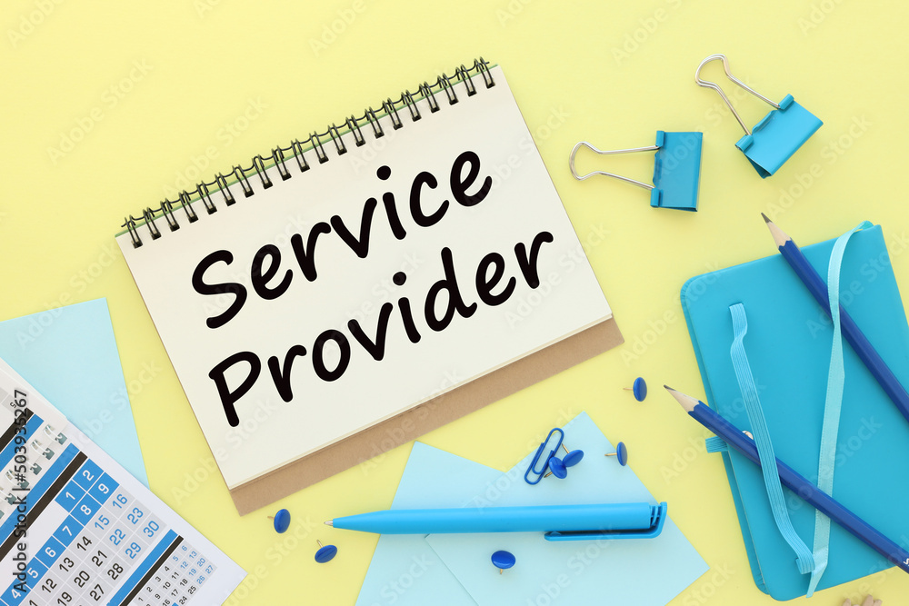 Service provider symbol. text on an open notepad on a yellow background and blue stationery Service provider symbol. text on an open notepad on a yellow background and blue stationery