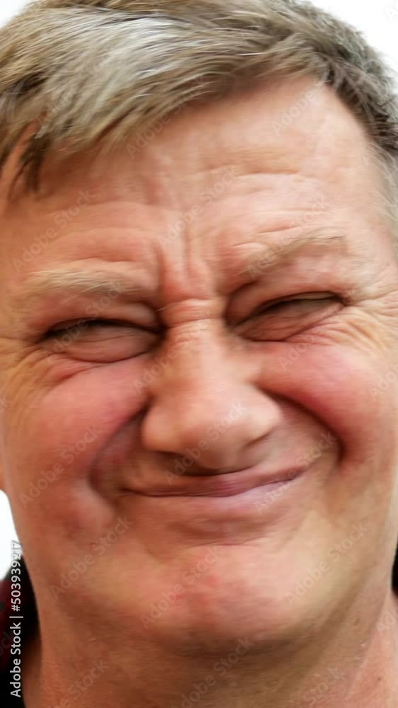 Elderly man with gray hair makes grimaces and negative gesture with his head. Elderly man with gray hair makes grimaces and negative gesture with his head.