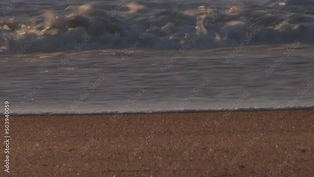 Foam from the waves of the sea that gently slide over the golden sand, image at sunset. Tranquility Foam from the waves of the sea that gently slide over the golden sand, image at sunset. Tranquility