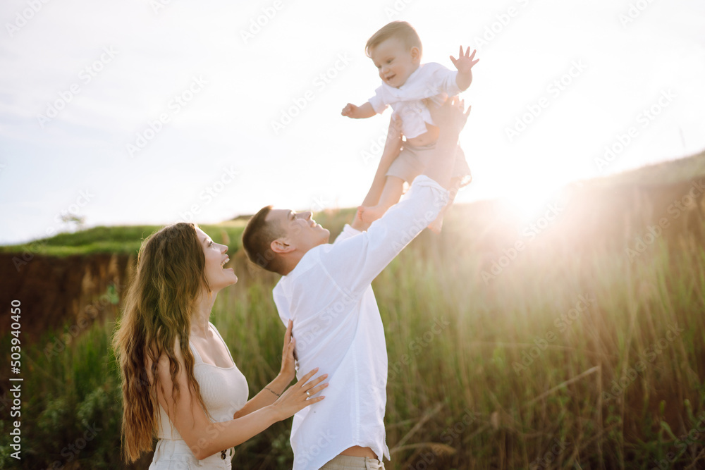 Father, mother and child resting on the beach. Young family are having fun on summer vacation. Travel, nature, active lifestyle, resort concept. Father, mother and child resting on the beach. Young family are having fun on summer vacation. Travel, nature, active lifestyle, resort concept.