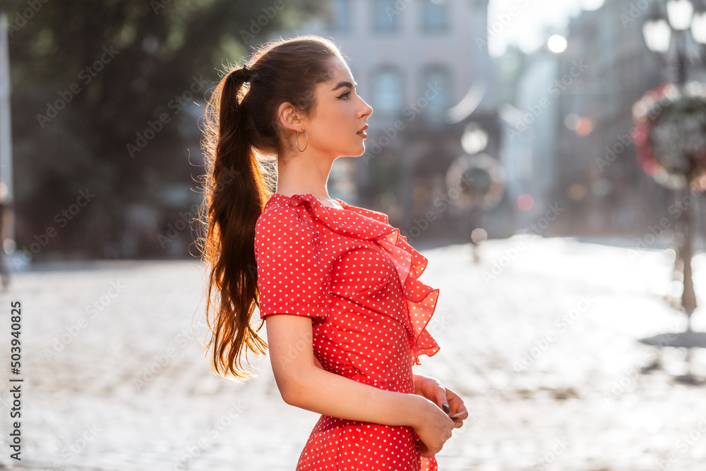 Beautiful girl in red dress with long hair ponytail Stock Photo | Adobe ...