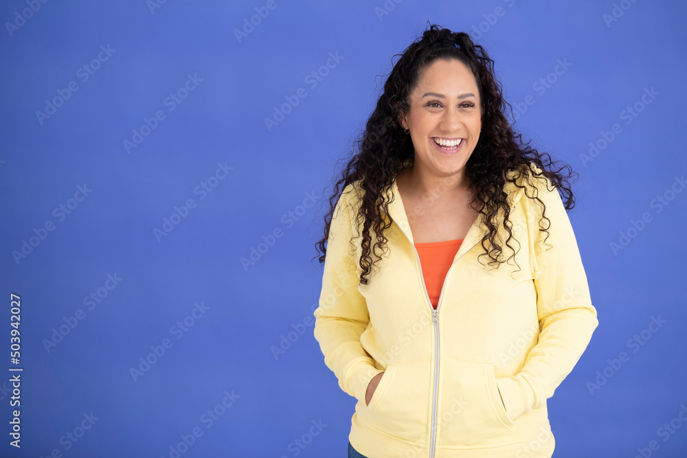 Studio portrait of mid adult woman in yellow sweatshirt Studio portrait of mid adult woman in yellow sweatshirt