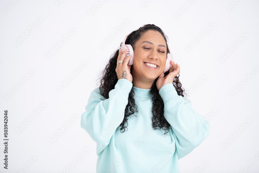 Studio portrait of mid adult woman wearing headphones Studio portrait of mid adult woman wearing headphones