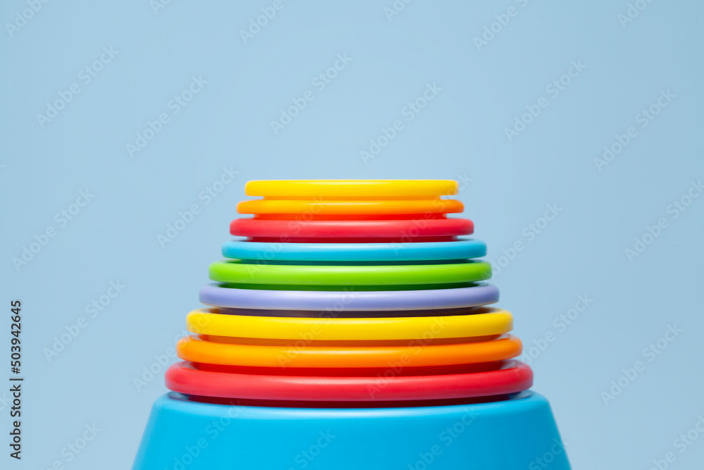 Colorful plastic cylinders rainbow on blue background Colorful plastic cylinders rainbow on blue background