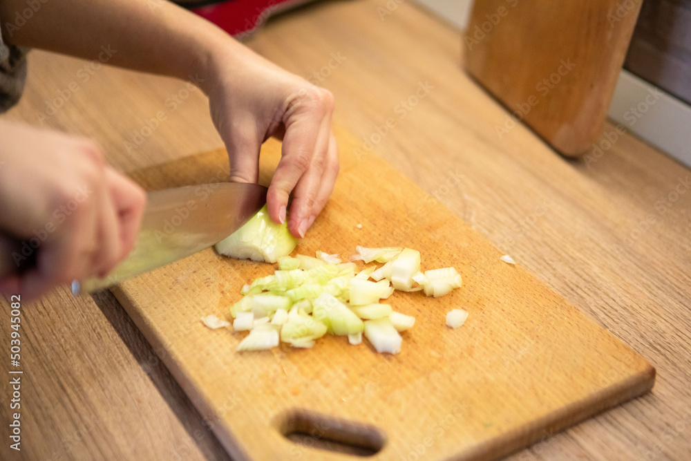 slicing onion on cut board
