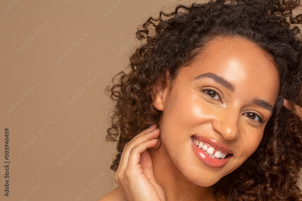 Close-up of smiling woman with curly hair Close-up of smiling woman with curly hair