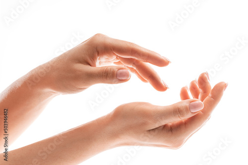 Female hands with soft skin and beautiful french manicure on white background
