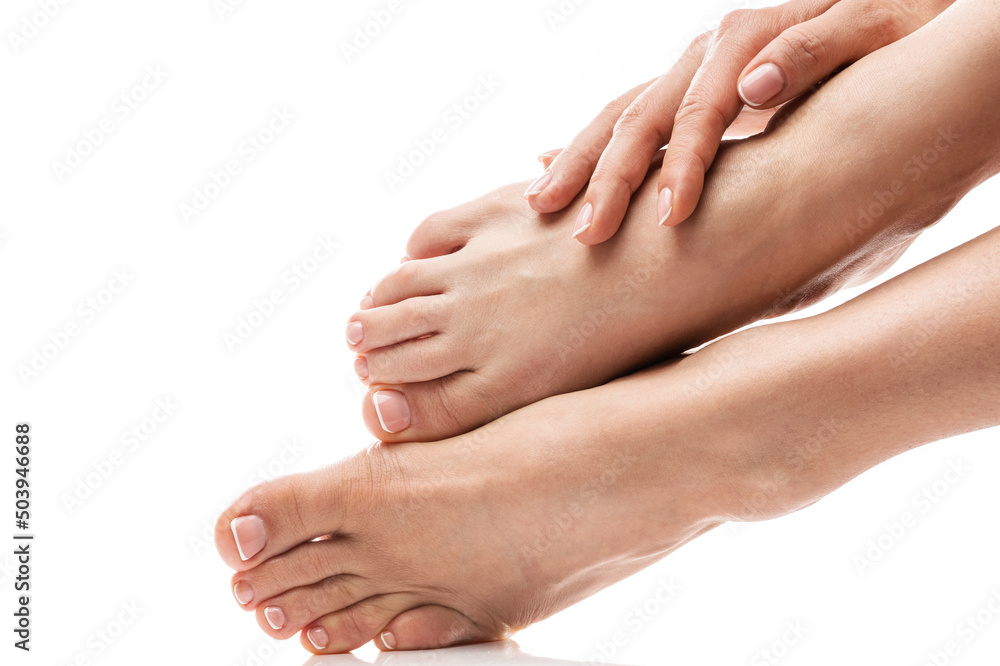 Female feet and hands with soft skin, french manicure and pedicure on white background Female feet and hands with soft skin, french manicure and pedicure on white background