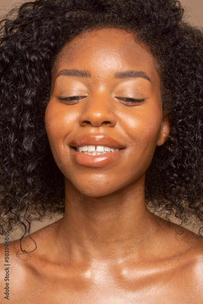 Studio portrait of smiling woman with curly hair Studio portrait of smiling woman with curly hair