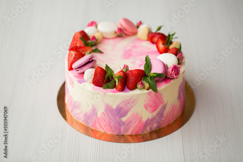 Beautiful cake with strawberries and macaroons