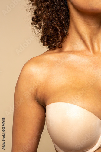 Close-up of woman in nude colored strapless bra