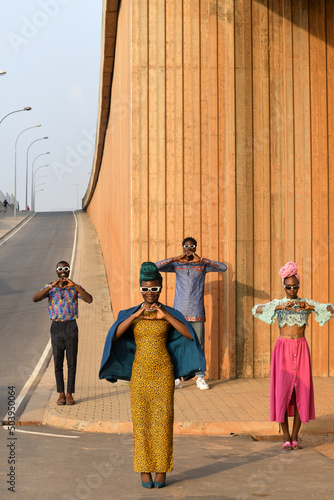 Fashion shot of four people standing in urban street