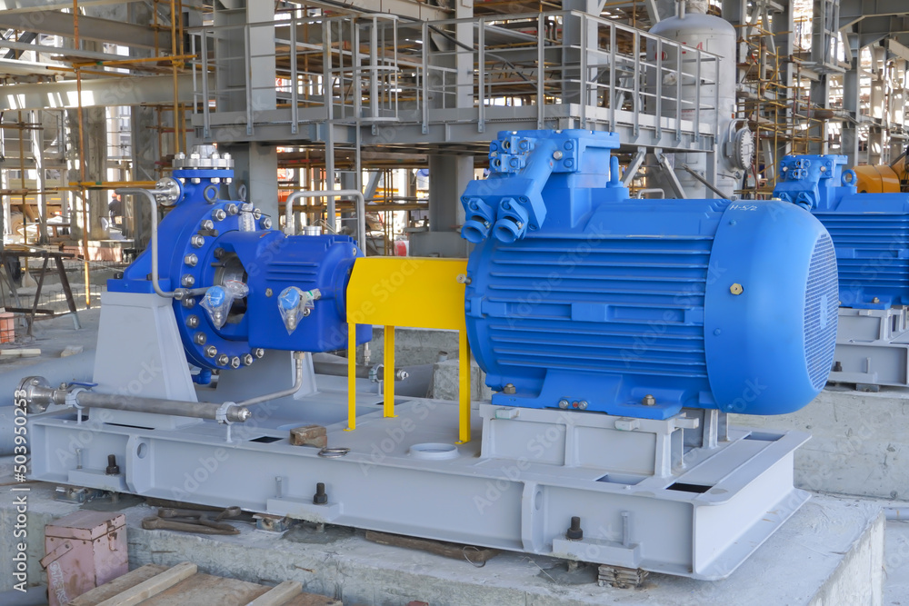 Industrial pump with an electric motor on a foundation for pumping oil and gas at a production site in Russia