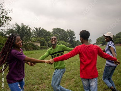 Group of young friends dancing in park