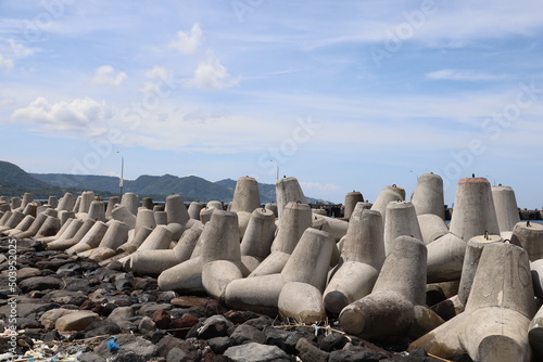 concrete tetrapods or dolos. wave barriers in the sea photo