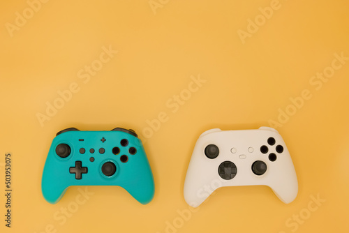 Joysticks gaming controller isolated on pastel yellow background, Video game console developed Interactive Entertainment