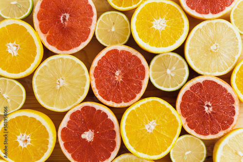 Different sliced citrus fruits such as grapefruit, orange, lemon and lime