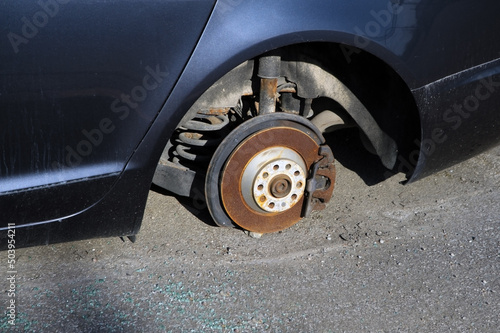 Car without wheel standing on brake disc