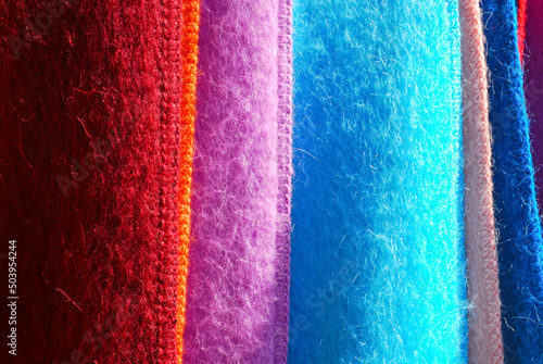 Close-up of variously colored Andes alpaca wool scarves for sale in a market in southern Chile