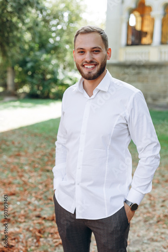 happy man smiling on his wedding day on nature background