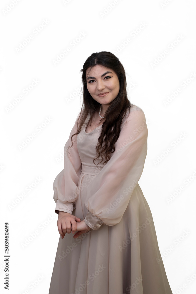 Portrait of happy beautiful woman in dress posing in studio isolated on white background. Portrait of woman with tied hands. Long black hair girl Portrait of happy beautiful woman in dress posing in studio isolated on white background. Portrait of woman with tied hands. Long black hair girl
