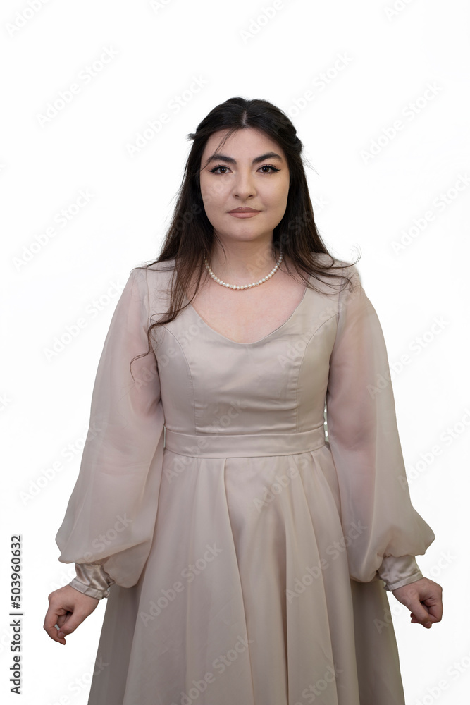 Portrait of woman in dress posing in studio isolated on white background. Long black hair girl