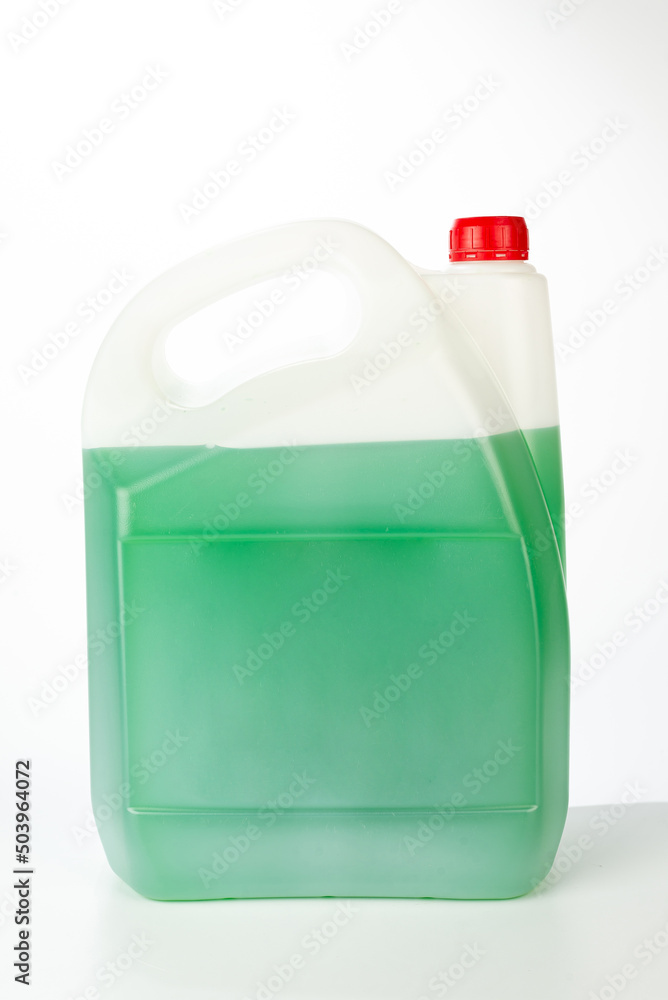 Green antifreeze in canister. Non-freezing cleaning liquid. There are places for a label. Frontal view. Green antifreeze in canister. Non-freezing cleaning liquid. There are places for a label. Frontal view.