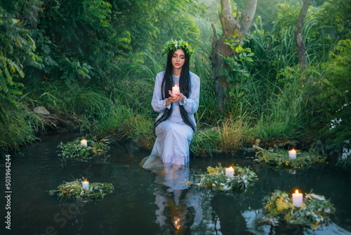 Fotografie fantasy pagan witch slavic woman holding candle in hand
