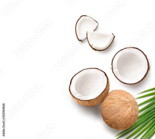Flat lay of Coconut fruit with cut in half and leaves isolated on white background.