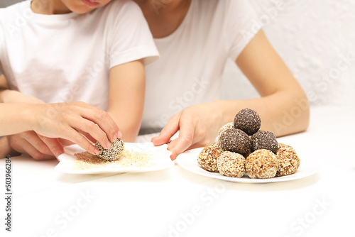 Cropped shot of mother and child making energy balls .