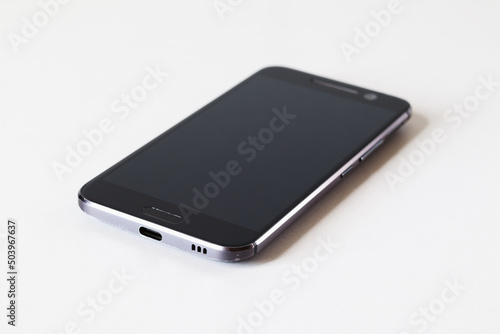 Smartphone on a white table close-up. Selective focus