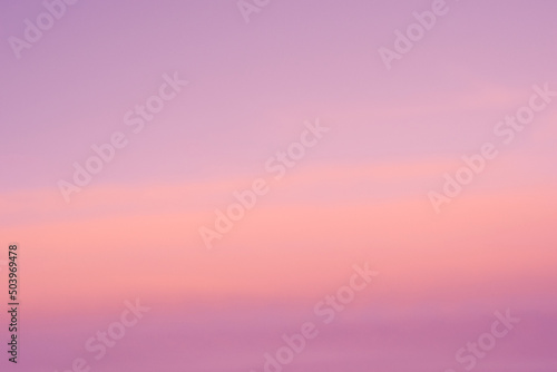 Background of sunrise sky with gentle colors of soft clouds. Dawn sky with colorfull clouds.
