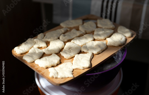 Preparation of traditional Kazakh pastries - baursaks. The cut pieces of dough are ready for frying. High quality photo photo