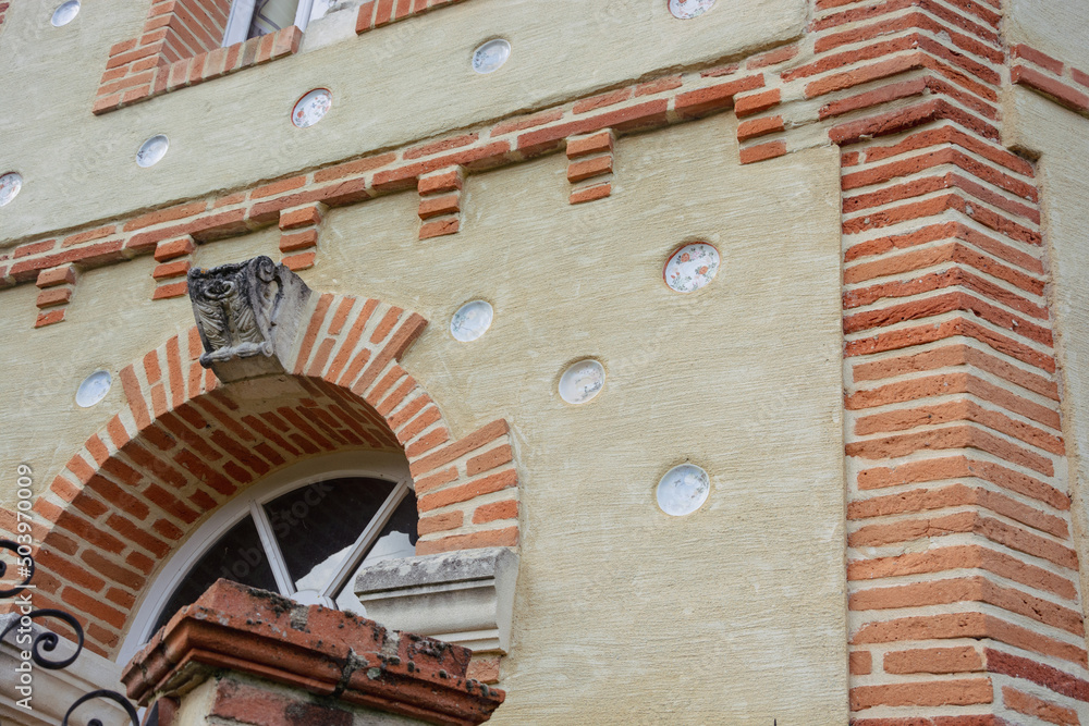 Fragment of the house decorated with plates in the in Rieux-Volvestre, Haute-Garonne, France in summer