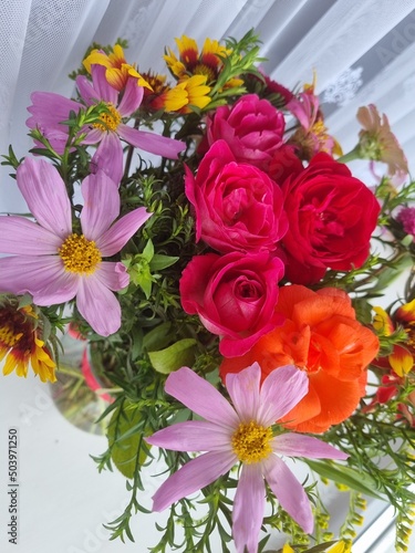 close-up photo of red and pink flowers. It is invitation  gift and a present. Concept of taking care and surprises