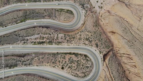 Aerial Top View Of The Serpentine Road With Several Hairpin Turns And Driving Car On The Hillside photo