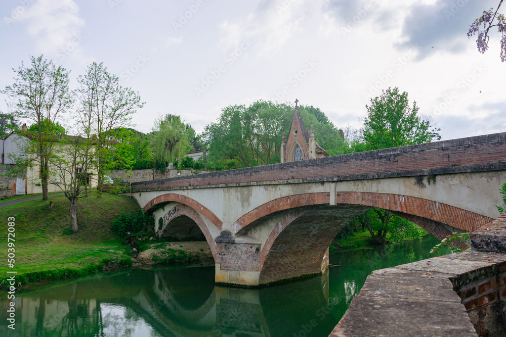 Bridge over river Arize in Rieux-Volvestre, France in summer