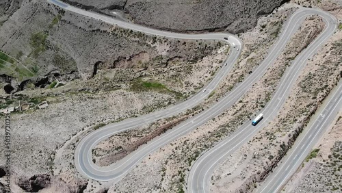 Aerial Top View Of The Road With Several Hairpin Turns And Driving Vehicles On The Hillside photo