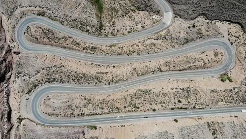 Aerial Top View Of The Winding Road With Several Hairpin Turns And Driving Vehicles photo
